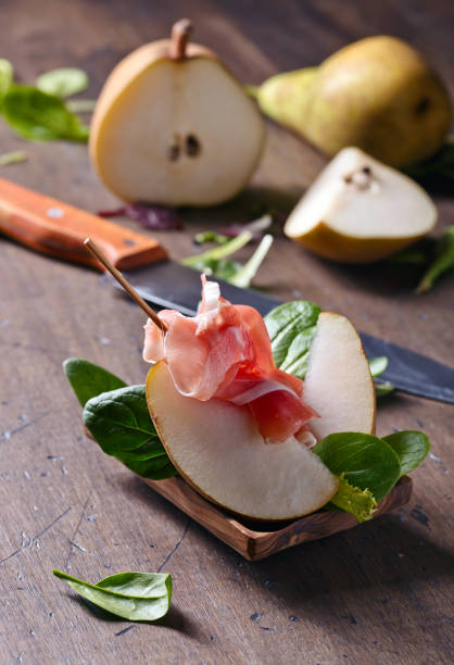 istock prosciutto with pear on a wooden table 653836240