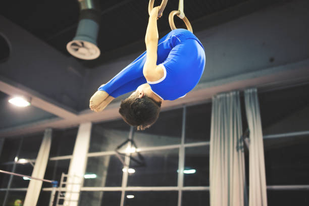 istock Boy exercising on gymnastic rings 653836570