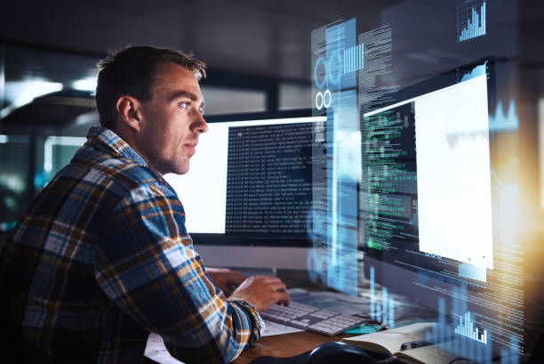 He puts the pro in programmer Shot of a young programmer working at his computer with an overlay of computer graphics it support stock pictures, royalty-free photos & images