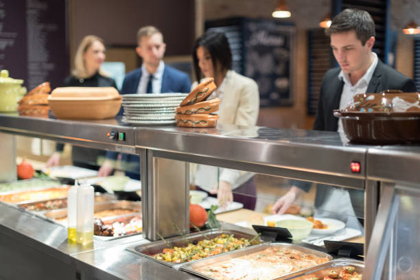 istock People in canteen waiting in line 653839420