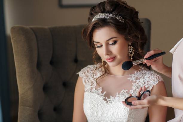istock Stylist-make-up artist makes make-up for young bride 653840584