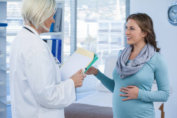istock Pregnant patient consulting a doctor 653841396