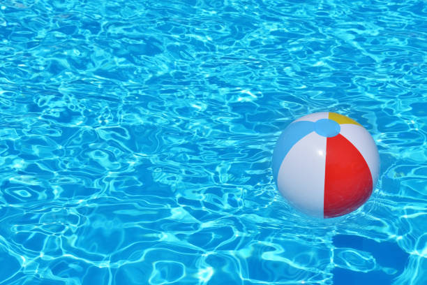 istock Colorful inflatable ball floating in swimming pool 653841492