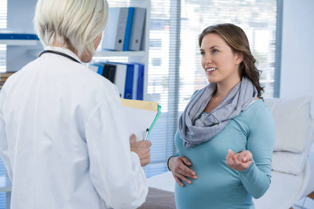 istock Pregnant patient consulting a doctor 653841500