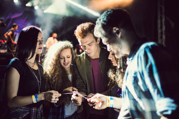 istock Friends light sparklers in front of concert stage 653841900