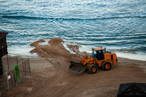 istock Bulldozer flattening out surface of the beach 653841950