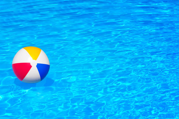 African woman having fun with beach ball at the beach