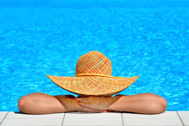 istock Real female beauty relaxing at swimming pool 653843630
