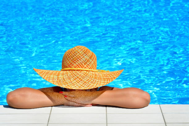 istock Real female beauty relaxing at swimming pool 653844112