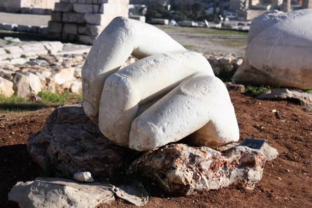 istock Hand in front Hercules temple at Citadel Hill Amman, Jordan 653844382