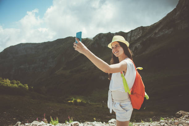istock Woman taking selfie photo in mountains 653845364
