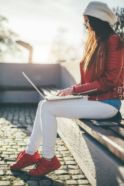 istock Smart beautiful woman working in park 653845678