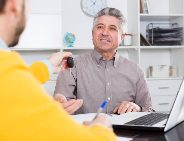 istock Mature man sign car purchase contract 653845952