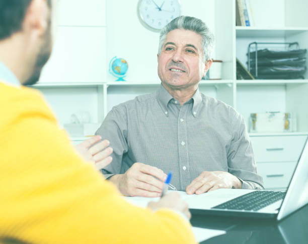 istock Men sign credit agreement 653845968
