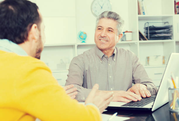 istock Men sign credit agreement 653846006