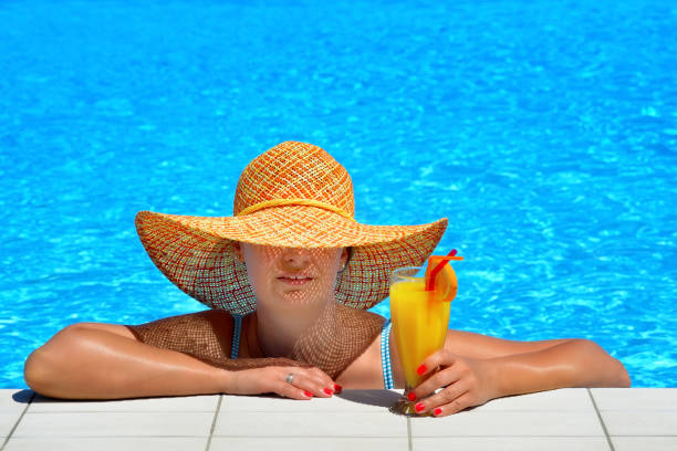 istock Real female beauty relaxing at swimming pool 653847014