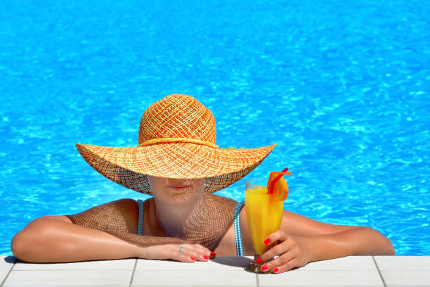 istock Real female beauty relaxing at swimming pool 653847178