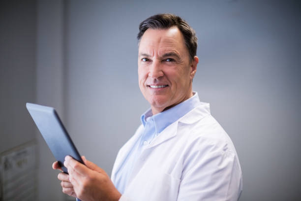 istock Portrait of male doctor using digital tablet 653847520