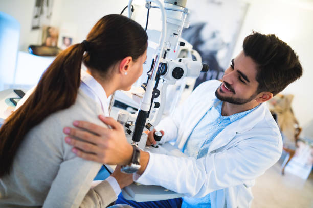 istock Young woman having her eyes examined by optometrist. 653848340