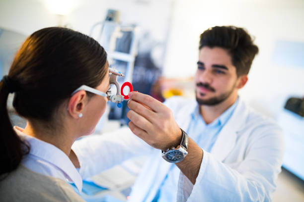 istock Young woman having her eyes examined by optometrist. 653848638