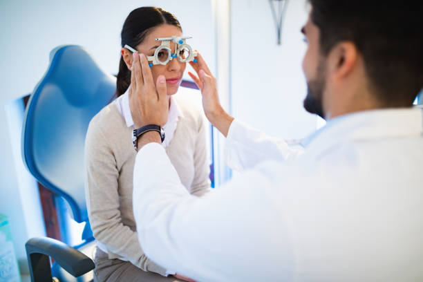 istock Young woman having her eyes examined by optometrist. 653848914
