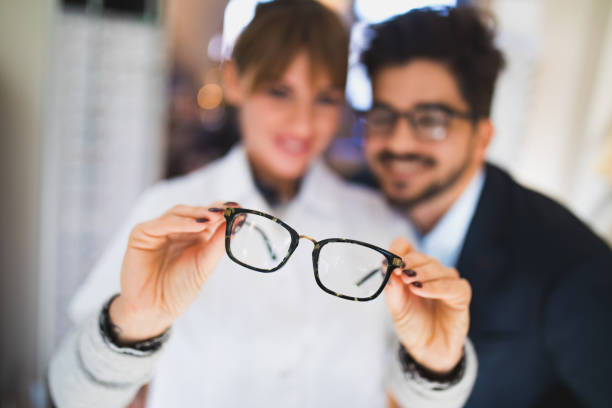 istock Young man selecting eyeglasses in optical shop 653849212