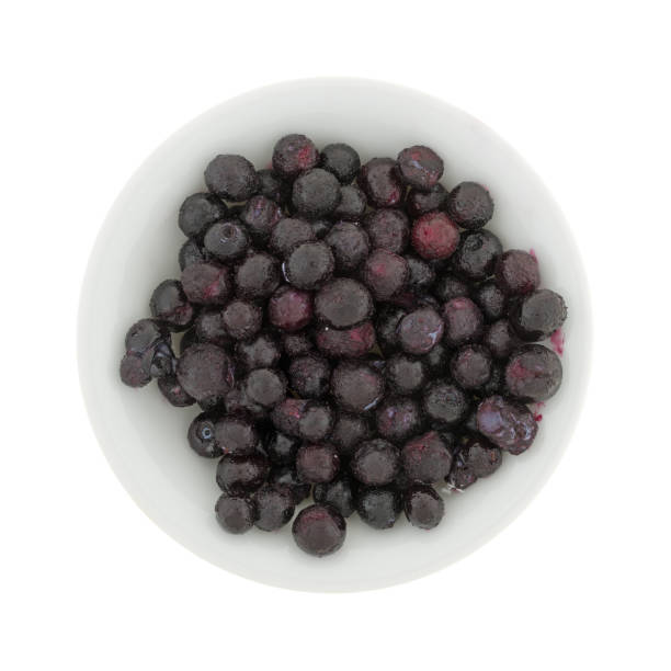 istock Frozen blueberries in a bowl on a white background 653849854
