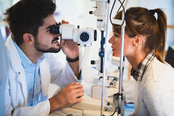 istock Young woman having her eyes examined by optometrist. 653850988