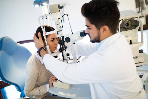 istock Young woman having her eyes examined by optometrist. 653851568