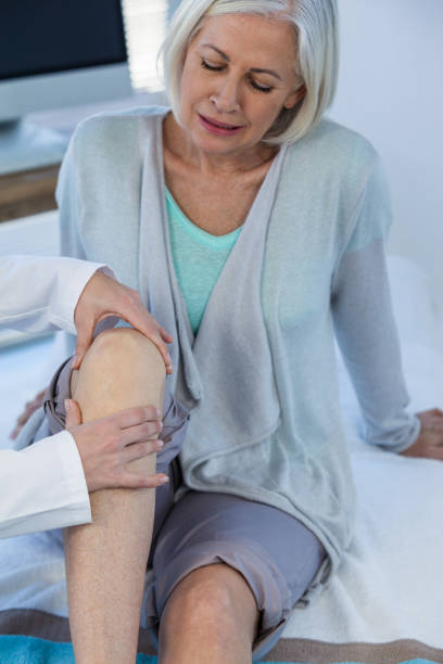 istock Doctor examining patient knee 653851718