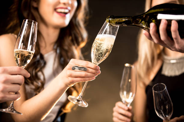 istock Happy friends drinking champagne 653852740