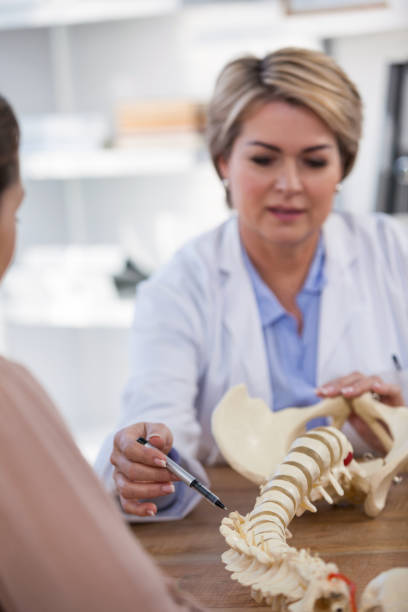 istock Doctor explaining anatomical spine to patient 653852918