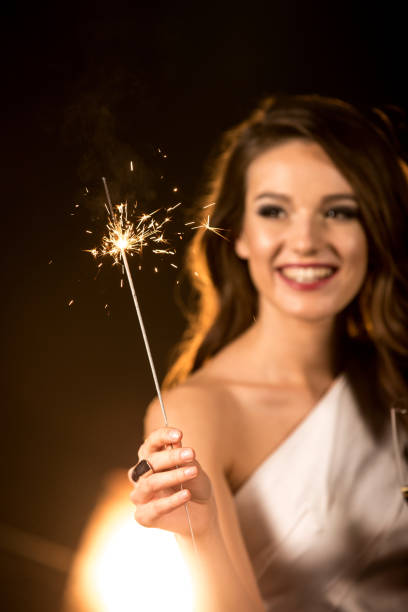 istock Beautiful woman holding sparkler 653852924