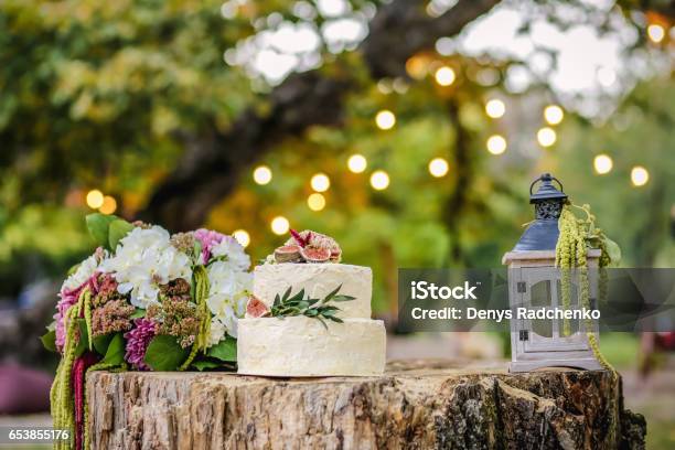 Beautiful Wedding Decoration With Cake Bouquet Of Flowers And A Lantern On A Background Of Nature Stock Photo - Download Image Now