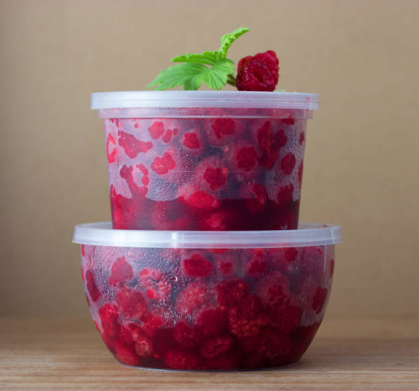 istock Raspberry in the round box with leaf of mint 653859434