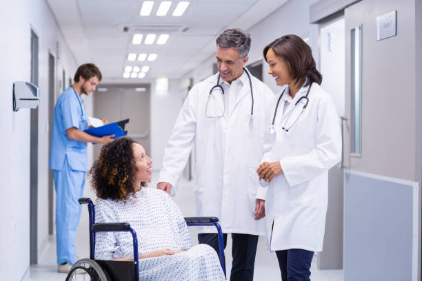 istock Doctors interacting with pregnant woman in corridor 653860774