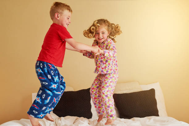 istock Kids know that beds were really made for jumping on 653860864