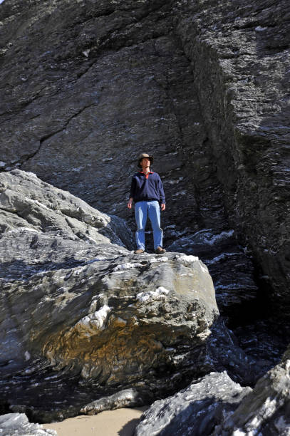 istock Man standing on edge of cliff. 653862930