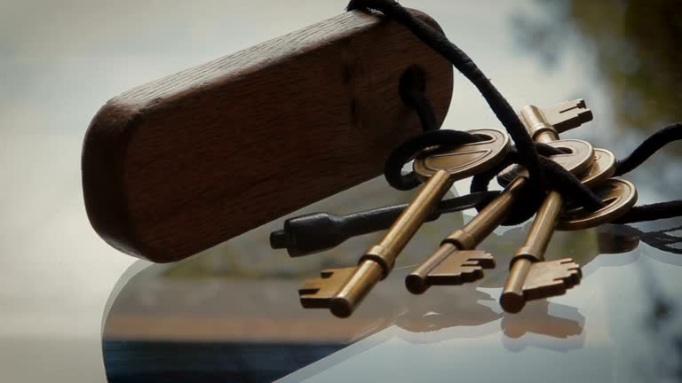 Bronze Keys tied with string to wooden key fob