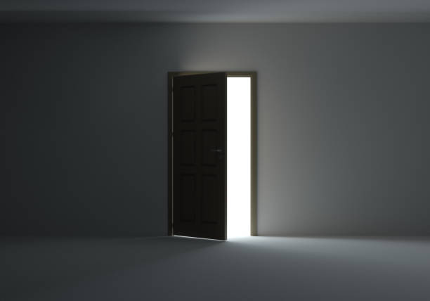 istock Open door with bright light streaming into very dark room 653868992