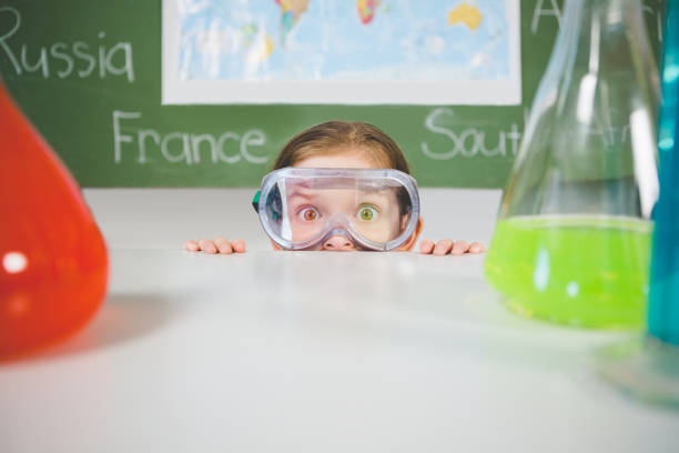 istock Schoolgirl doing a chemical experiment in laboratory 653871292