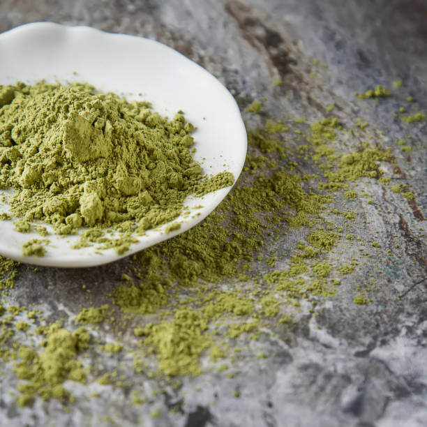 istock Matcha tea on a small white plate. Gray background. Top view. Square image 653872278
