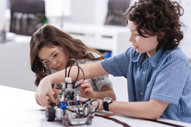 istock Enthusiastic kids enjoying science class at school 653872396