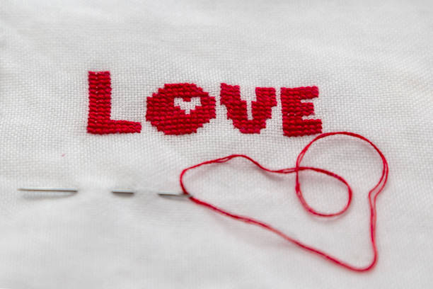 istock The word love embroidered red thread on white fabric. 653872562