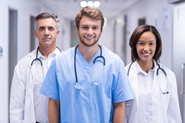 istock Portrait of smiling doctors standing in corridor 653873100