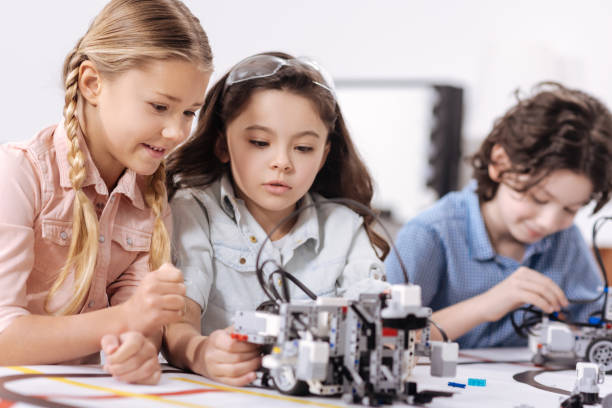istock Pleasant children discussing science at school 653873370