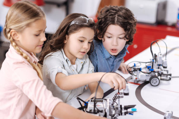 istock Lively children discussing project at school 653873634