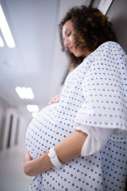 istock Pregnant woman standing in corridor 653873744