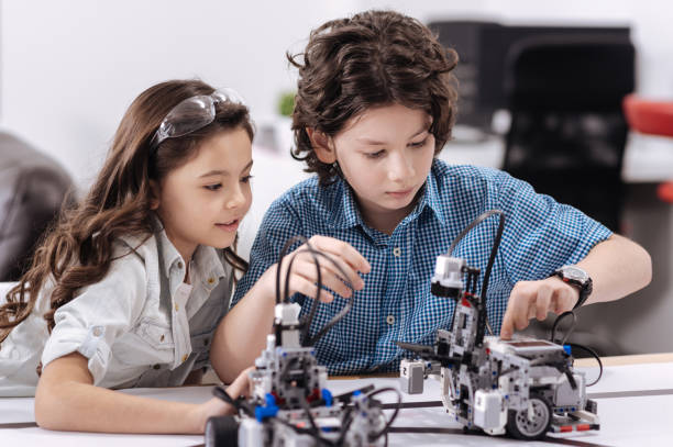 istock Concentrated little scientists enjoying tech lesson at school 653874136