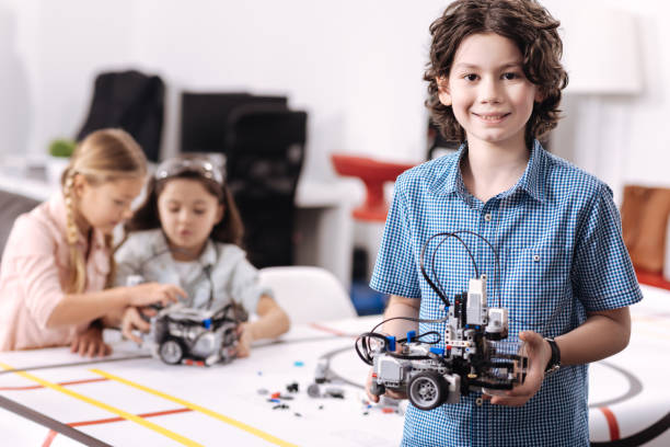 istock Positive pupil demonstrating tech project at school 653874256